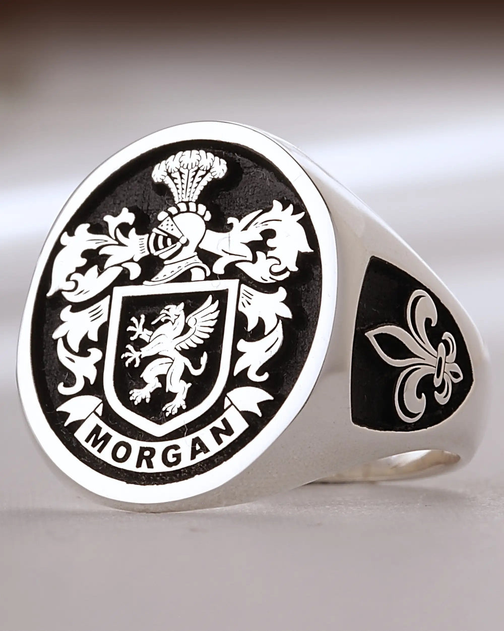 Sterling silver signet ring with the Morgan family crest engraved on a black background and a fleur-de-lis on the side
